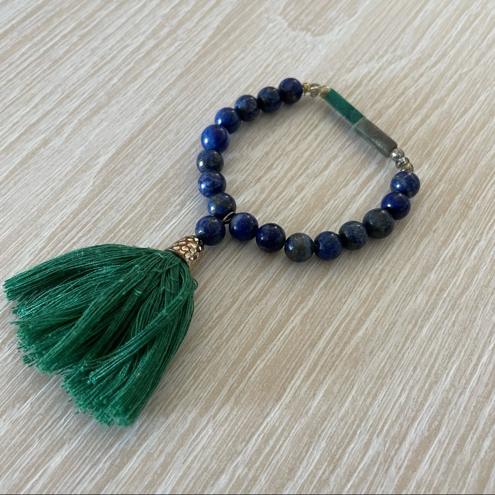 Lapis blue stretch bead bracelet with green tassel